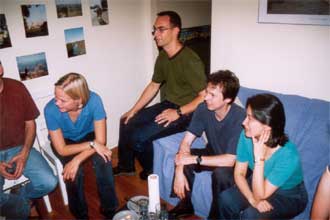 Kumi, Mark, Henrik, and Eva watch Trevor make a cute heart shape with his hands